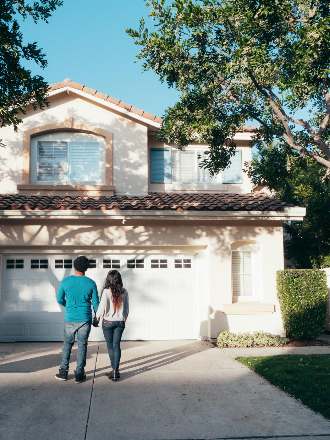 Couple in front of their new home